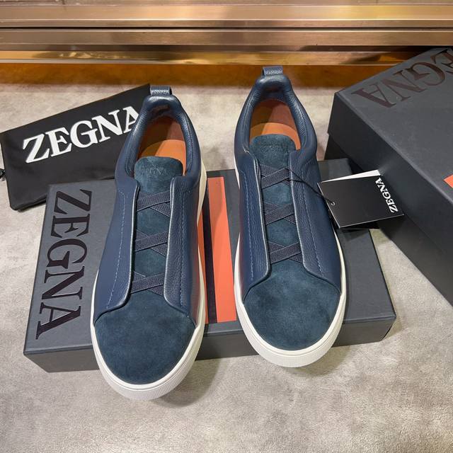 Ermenegildo Zegna 杰尼亚 光滑皮革 Tiziano 低帮运动鞋 这款tiziano 低帮运动鞋摔花纹牛皮制成，饰以丰富的工艺细节，如骆马红棕色