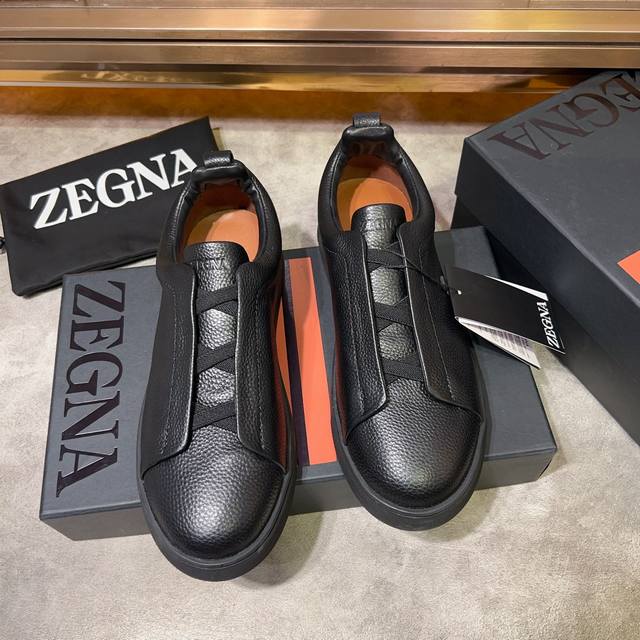 Ermenegildo Zegna 杰尼亚 光滑皮革 Tiziano 低帮运动鞋 这款tiziano 低帮运动鞋摔花纹牛皮制成，饰以丰富的工艺细节，如骆马红棕色